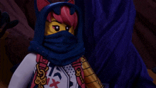 a ninjago character with a blue hood and a white shirt with a red cross on it