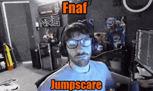 a man wearing glasses and headphones is sitting in front of a sign that says nrg