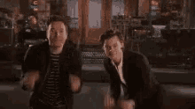 a couple of men are dancing together in a room .