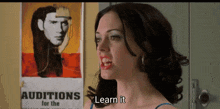a woman is standing in front of a sign that says auditions for the