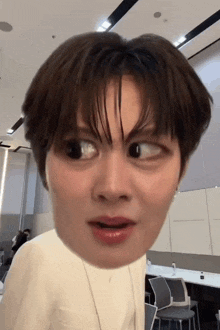 a close up of a person 's face making a funny face in a room .