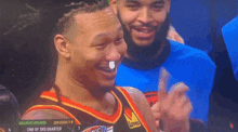a basketball player wearing a jersey that says den lewis on it