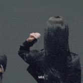 a woman in a black jacket has the word sill on the bottom