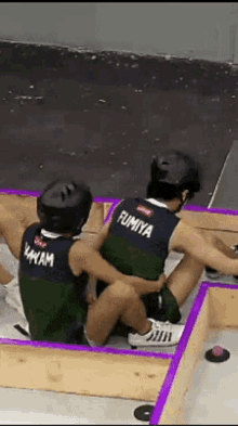 two people are playing a game and one of them has the name fumiya on the back of his shirt