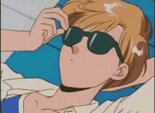 a cartoon character is wearing sunglasses while laying on a blue chair .