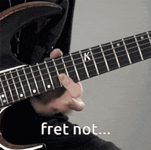 a person is playing an electric guitar with the words fret not written below it