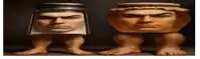 a statue of a man 's head sitting next to another statue of a man 's head sitting on legs