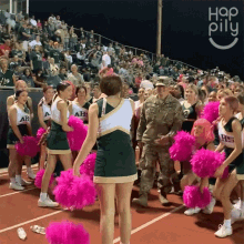 a cheerleader wearing a green and white uniform with the letters rs on the back