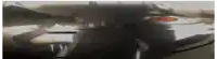 a blurred image of a person standing in front of a car .