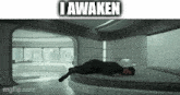 a man is laying on a bed in a room with the words `` i awaken '' written on it .