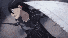 a man is holding a sword with the letter l on the sleeve