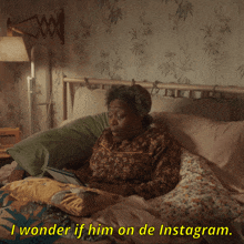 an elderly woman is laying in bed with a tablet and the caption says i wonder if him on de instagram