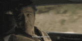 a man sitting in the back seat of a car says i 'll meet you there