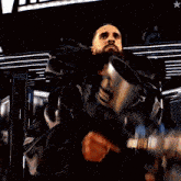a man holding a gun in front of a sign that says wrestleview