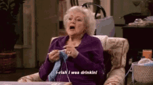 an elderly woman is sitting in a chair knitting and saying `` i - rish i was drinkin ! ''