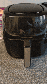 a black russell hobbs air fryer is on a counter