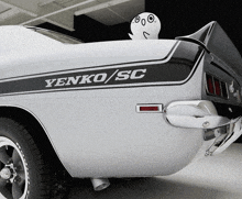 a white car with a black stripe that says yenko / sc