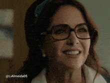 a close up of a woman wearing glasses and a headband
