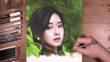 a person is drawing a woman 's face with a pen