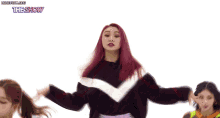 a woman with red hair is dancing in front of a white background with the show written above her