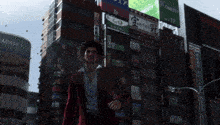 a man in a red suit stands in front of a building that says adise city