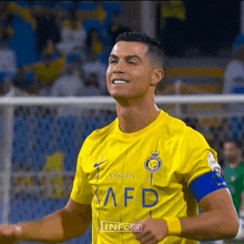 a soccer player wearing a yellow shirt that says infogif