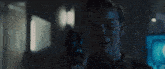 a man is holding a gun in his hand in a dark room