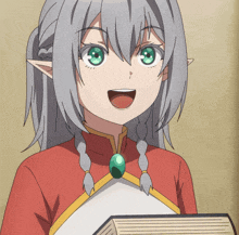 a girl with gray hair and green eyes is smiling while holding a book