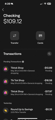 a phone screen shows a checking account with $ 109.12 in it
