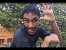a young man making a funny face with his hand