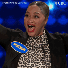 a woman in a leopard print top has a name tag that says schevon