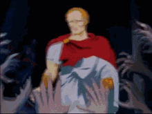 a man in a red cape is surrounded by hands