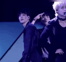 a group of young men are dancing on a stage .