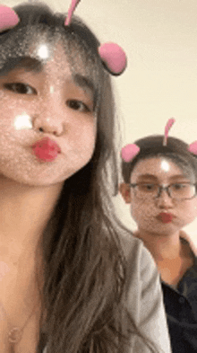 a woman and a man are taking a selfie with their faces covered in bubbles .