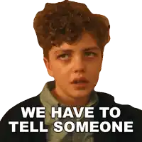 a young boy with curly hair has the words we have to tell someone on his face