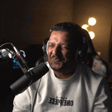 a man wearing headphones and a one piece t-shirt