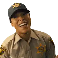 a woman in a sheriff 's uniform is laughing