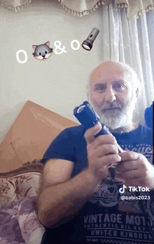 a man with a beard is holding a flashlight and wearing a vintage shirt