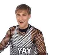 a man wearing a fishnet top with the word yay on it