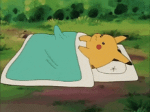 a pikachu is laying on a bed with a blue blanket and a white pillow