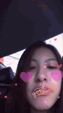 a woman in a car with hearts on her face and the word morning written on the bottom