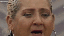 a woman is crying with the words te amo mi amor written on her face