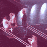 a man stands on a stage talking to a woman