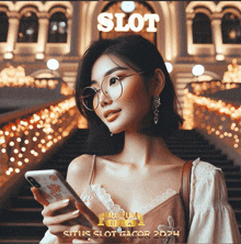 a woman wearing glasses is holding a cell phone in front of a building with the word slot on it