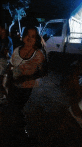 a woman is dancing in front of a truck that says ' toyota ' on it