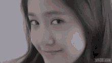 a close up of a woman 's face with her eyes closed and smiling .