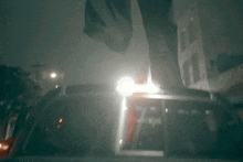 a person standing on top of a car with a light on