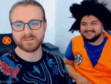 a man with glasses and a man with a wig are standing next to each other and smiling .