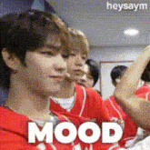 a group of people are sitting in a room and the word mood is on the screen