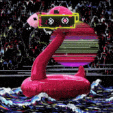 a pink flamingo floating in the water with a yellow box on it
